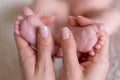 Newborn or Baby born. Child or kid feet in mother hand. New Mom or mother doing a massage. Barefoot baby Royalty Free Stock Photo