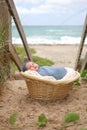 Newborn Baby Boy in Basket at Beach Royalty Free Stock Photo