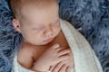 Newborn baby boy in bed. New born child sleeping under a white knitted blanket. Children sleep. Royalty Free Stock Photo