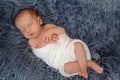 Newborn baby boy in bed. New born child sleeping under a white knitted blanket. Children sleep. Royalty Free Stock Photo