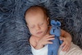 Newborn baby boy in bed. New born child sleeping under a white knitted blanket. Children sleep. Royalty Free Stock Photo