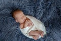 Newborn baby boy in bed. New born child sleeping under a white knitted blanket. Children sleep. Royalty Free Stock Photo