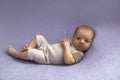 Newborn baby boy on blue textile background. Royalty Free Stock Photo