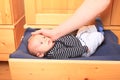 Newborn baby boy lying in wooden drawer