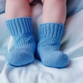 Newborn baby boy feet in blue knitted socks close-up. AI generated picture