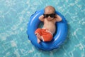 Newborn Baby Boy Floating on an Inflatable Swim Ring Royalty Free Stock Photo