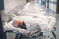 Newborn baby in first of many small hospital beds Royalty Free Stock Photo