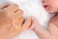 Newborn baby boy holding little finger of father`s hand Royalty Free Stock Photo