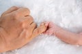 Newborn baby boy holding little finger of father`s hand Royalty Free Stock Photo