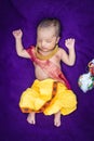 newborn baby boy in krishna dressed with props from unique perspective in different expression