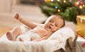 Newborn baby boy lying in basket at living room decorated for Ch