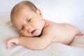 Newborn baby boy lying and sleeping on white bed at home Royalty Free Stock Photo