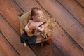 Newborn Baby Boy Playing a Tiny Guitar Royalty Free Stock Photo