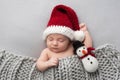 Newborn Baby Boy with Santa Hat and Snowman Plush Toy Royalty Free Stock Photo