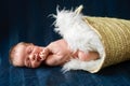A newborn baby boy sleeping in the basket Royalty Free Stock Photo