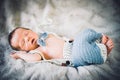 A newborn baby boy sleeping in knitted bow tie and trousers Royalty Free Stock Photo