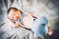 A newborn baby boy smiling in knitted bow tie and trousers Royalty Free Stock Photo