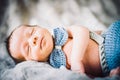 A newborn baby boy sleeping in knitted bow tie and trousers Royalty Free Stock Photo