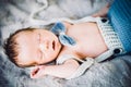 A newborn baby boy sleeping in knitted bow tie and trousers Royalty Free Stock Photo