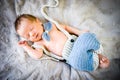 A newborn baby boy sleeping in knitted bow tie and trousers Royalty Free Stock Photo