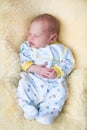 Newborn baby boy sleeping on a sheepskin Royalty Free Stock Photo