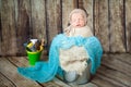 Newborn baby boy sleeping in a silver metal bucket Royalty Free Stock Photo