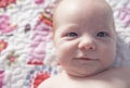 Newborn baby boy smiling on the bed Royalty Free Stock Photo