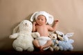 Newborn baby boy wearing a brown knitted rabbit hat and pants, s Royalty Free Stock Photo
