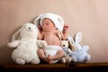 Newborn baby boy wearing a brown knitted rabbit hat and pants, s Royalty Free Stock Photo