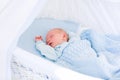 Newborn baby boy in white bassinet Royalty Free Stock Photo