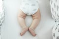 Newborn baby boy in white bodysuit with clouds in bed. New born child sleeping. Children sleep Royalty Free Stock Photo