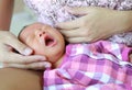 Newborn baby boy  yawning on mother lap Royalty Free Stock Photo