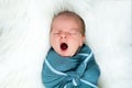 Newborn baby boy yawning