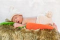 Newborn baby in bunny costume sleeping on fur bed Royalty Free Stock Photo