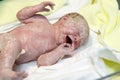 Newborn baby child seconds and minutes after birth lying on towel Royalty Free Stock Photo