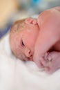 Newborn baby child seconds and minutes after birth lying on towel Royalty Free Stock Photo