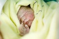 Newborn baby child seconds and minutes after birth wrapped in towel