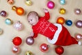 Newborn baby with Christmas tree decoarations and colorful toys and balls Royalty Free Stock Photo