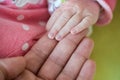 Newborn baby, closeup of fingers of fingers on hand of mother Royalty Free Stock Photo