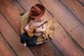 Newborn Baby Cowboy Playing a Tiny Guitar Royalty Free Stock Photo