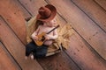 Newborn Baby Cowboy Playing a Tiny Guitar Royalty Free Stock Photo