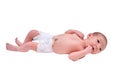 A newborn baby in diapers on a white changing table with a ruler for m Royalty Free Stock Photo