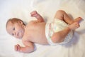 Newborn baby dressed in diaper, lying on a white background Royalty Free Stock Photo