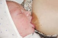 Newborn baby eats mom`s milk for the first time concept of natural feeding