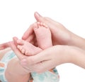 Newborn baby feet cupped into mothers hands. isolated on white Royalty Free Stock Photo