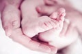 Newborn baby feet in mommy's hand