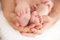 Newborn baby feet in mommy's hands