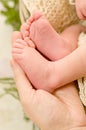 Newborn baby feet in a mother hand Royalty Free Stock Photo