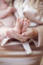 Newborn Baby feet in mother hands closeup Royalty Free Stock Photo