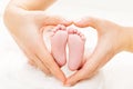 Newborn Baby Feet in Mother Hands Heart, Mom and New Born Kid Foot Royalty Free Stock Photo